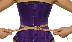 Woman measuring her waist